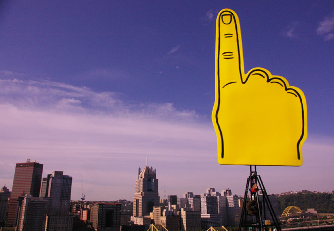 Giant foam hand that likes pigeons looking over
		 Pittsburgh, robotic art by artist Ian Ingram.